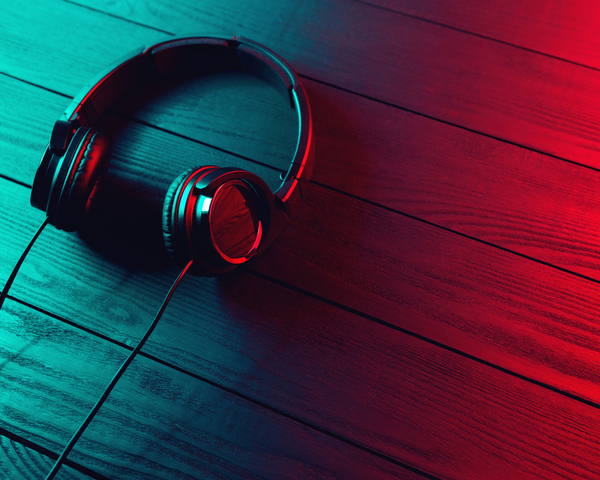 Black headphones on dark wooden background
